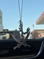 Car air freshener with a design of crossed swords and a hand holding a dagger, hanging from a chain inside a car.