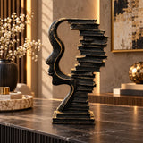 Abstract face sculpture with books table decor