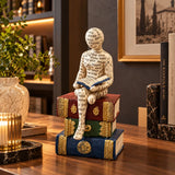Ivory seated reader with open book sculpture