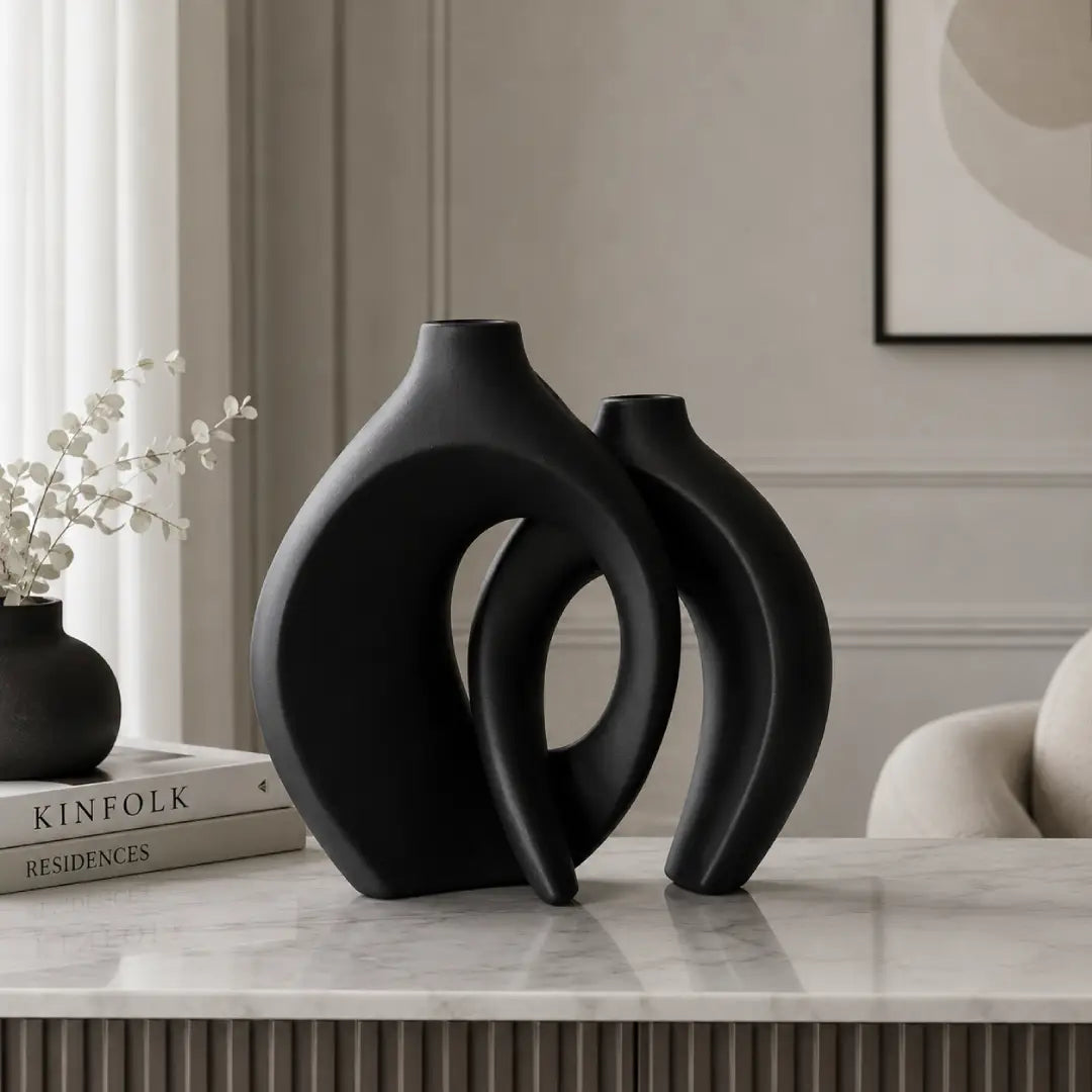 Golden modern abstract interlocking decorative vases with dried grass