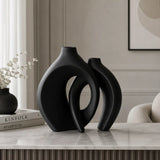 Golden modern abstract interlocking decorative vases with dried grass
